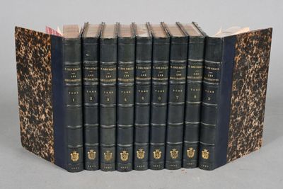 the books are lined up in a row on a gray surface