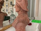 a bust of a woman sitting on a table in front of a mirror