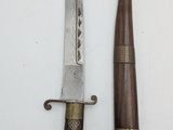 two knives that are on the table next to each other