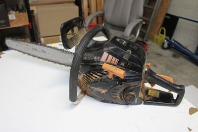a chainsaw sitting on a table in a garage