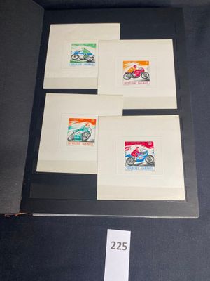 four different stamps are displayed in a display case on a table