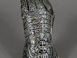 a silver and gold figurine of a woman ' s head