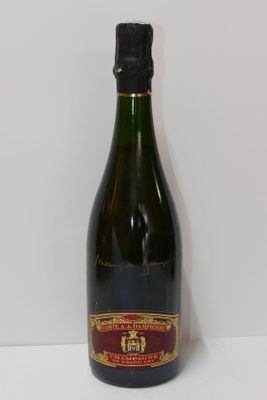 an empty bottle of wine sitting on top of a white table