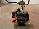 a small engine sitting on the floor in a garage