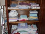 a wooden cabinet with a lot of folded towels on it