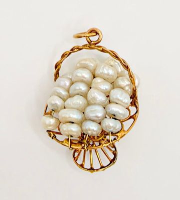 a picture of a gold and pearl pendant on a white background