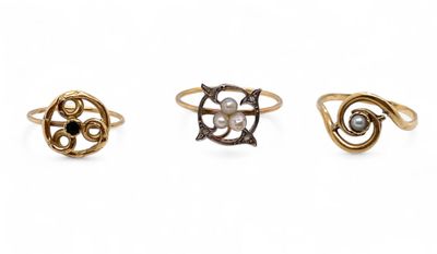 three different rings with pearls on them on a white background