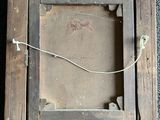 a picture of an old wooden picture frame on the floor