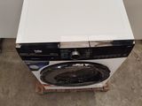 an image of a washing machine in the corner of a room