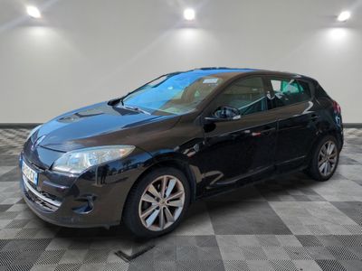 the black car is parked in the garage on the checkered floor