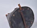 an old suitcase with a leather handle on a white surface