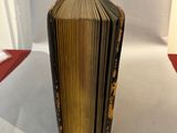 a book that is sitting on a table next to a piece of paper
