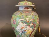 an image of a colorful vase with a lid on a table