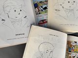 three pages of comics are spread out on a table