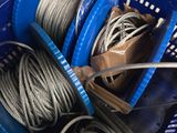 a blue basket filled with wires and a pair of scissors