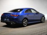 the rear end of a blue mercedes cla parked in a garage