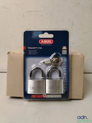 a close up of two padlocks in a package on a table