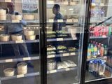 a glass case with food inside of it in a store