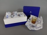 a blue box with a glass in it next to a blue and white box