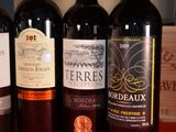 several bottles of wine are lined up on a table