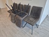 four chairs that are sitting in a row in a room