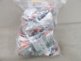 a bag of toothpaste and toothbrushes sitting on a couch