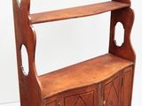 an old wooden bookcase with two open shelves and two doors