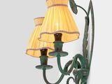 a wall mounted lamp with two lamps attached to it