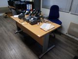 a desk with a bunch of telephones on it