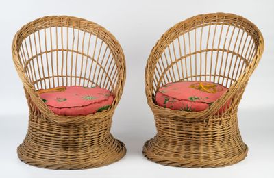 pair of wicker chairs with pink cushions on a white background