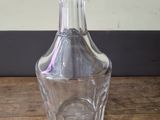 a clear glass vase sitting on a wooden table