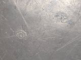 a close up of a metal surface with scratches on it