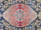 a red and blue rug with a medallion design on it