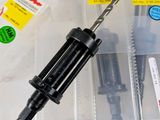 a screw and screwdriver in a plastic case
