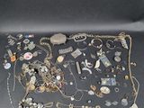 an assortment of jewelry including a necklace, bracelet, ring, and other items