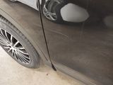 a close up of a car door with a reflection of a person on it