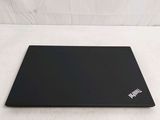 a black laptop sitting on top of a white sheet