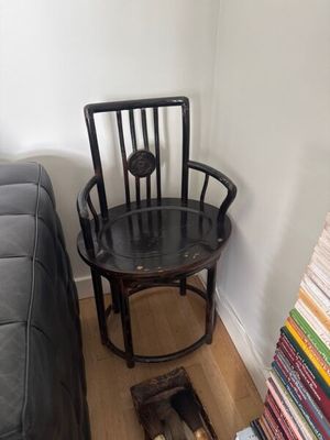 une chaise posée à côté d'une pile de livres posée par terre