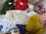 a basket full of clothes that is sitting on the floor