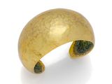 an image of a close up of a gold ring on a white surface