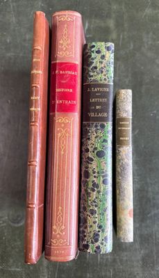 several books are lined up on a table with a black background