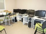 a room with a bunch of computers on the desk