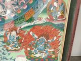 framed picture of a painting of a buddhist painting of a man riding a horse