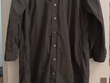 black shirt hanging on a white door in a room