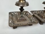 two candles that are sitting on a tray on a table