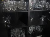many glasses on the shelves in the room
