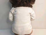 a baby that is sitting on the floor with its head down