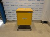 an image of a yellow box sitting in front of a wall