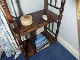 a small wooden shelf with a cake on top of it
