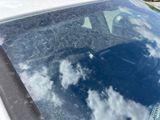 a car that has a broken windshield with a cloud in the window